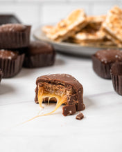 Load image into Gallery viewer, Piece of milk caramel with a bite taken out of it